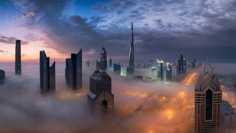A breathtaking sunrise in Dubai as thick fog pours though the futuristic and beautiful city skyline.