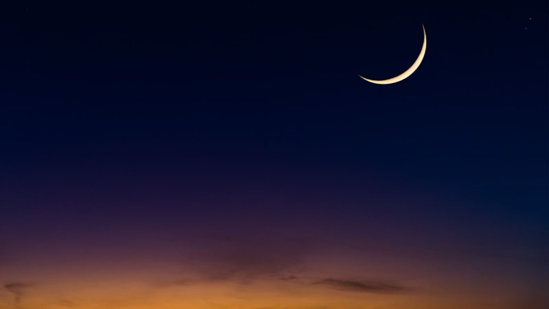 Islamic Moon sky on Dark Blue Dusk,Twilight Sky in the Evening with Sunset and Beautiful Sunlight dark cloud and Crescent moon, symbol of religion islamic begin Ramadan month, Eid al-Adha, Eid al fitr